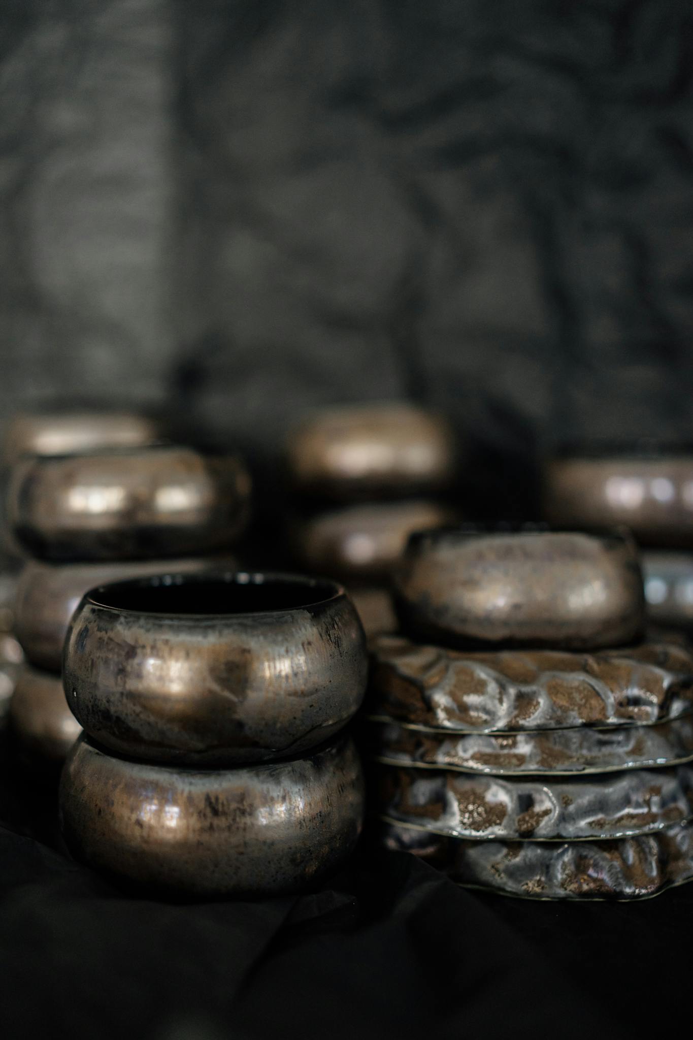 A collection of handmade bronze pottery showcasing intricate designs and craftsmanship.